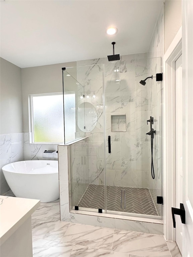 635 Lily St, Prairie View, TX 77484 - bathroom featuring a freestanding tub, marble finish floors, a marble finish shower, a wainscoted wall, and vanity