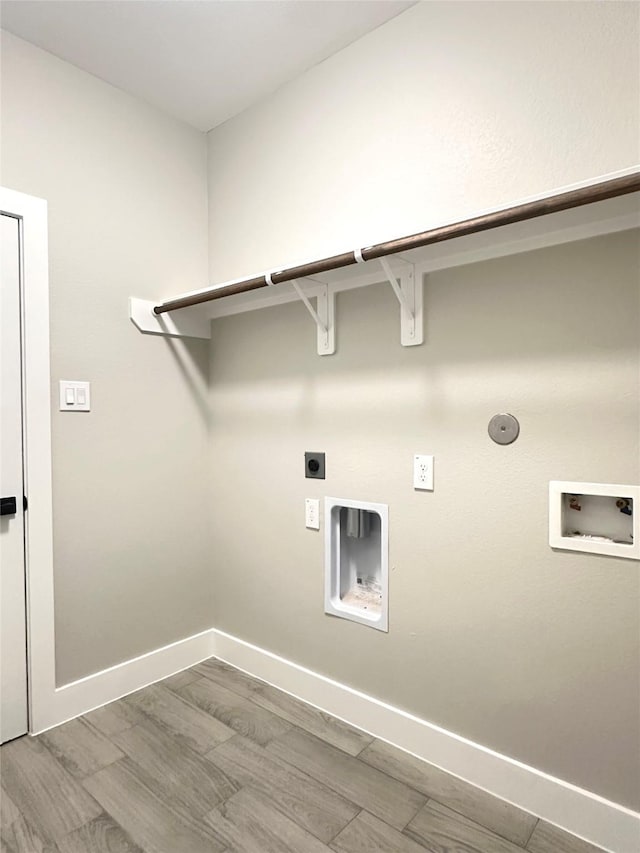 635 Lily St, Prairie View, TX 77484 - laundry room featuring washer hookup, hookup for an electric dryer, baseboards, wood finished floors, and gas dryer hookup