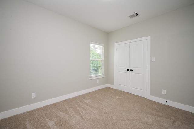 635 Lily St, Prairie View, TX 77484 - unfurnished bedroom with light colored carpet and a closet