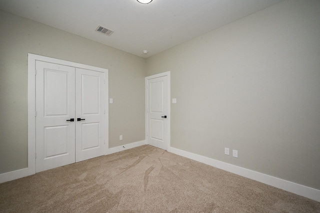 635 Lily St, Prairie View, TX 77484 - unfurnished bedroom featuring light carpet and a closet