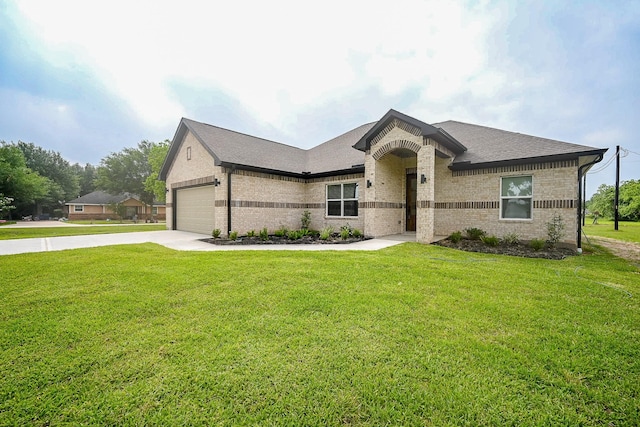 635 Lily St, Prairie View, TX 77484 - french country inspired facade featuring concrete driveway, brick siding, a front lawn, and an attached garage