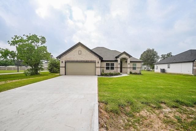 635 Lily St, Prairie View, TX 77484 - french country inspired facade with brick siding, an attached garage, driveway, and a front yard