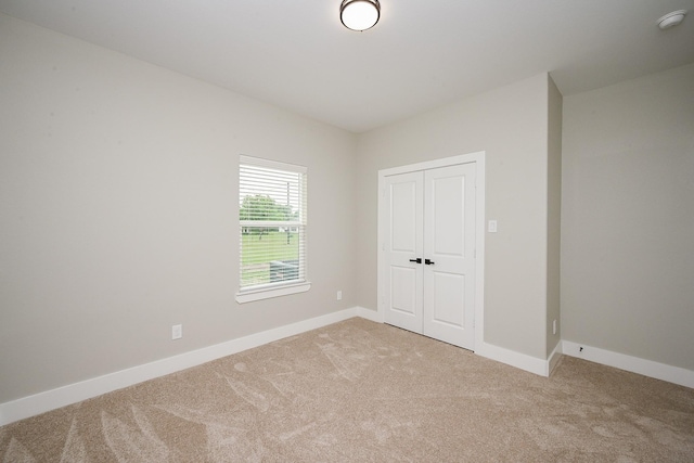 635 Lily St, Prairie View, TX 77484 - unfurnished bedroom featuring light carpet and a closet