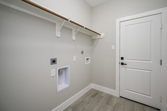 635 Lily St, Prairie View, TX 77484 - laundry room featuring electric dryer hookup, light wood-style flooring, and hookup for a washing machine