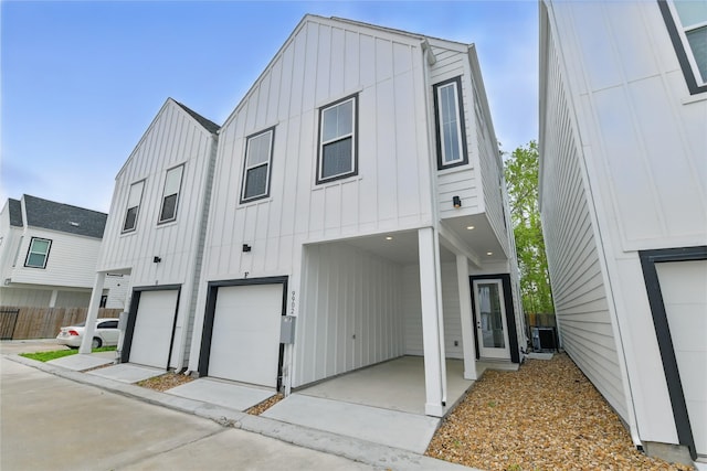 view of front facade with board and batten siding and fence