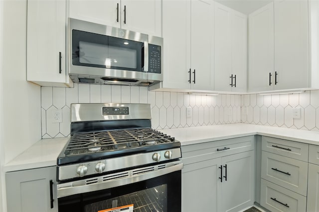kitchen with decorative backsplash, light countertops, and stainless steel appliances