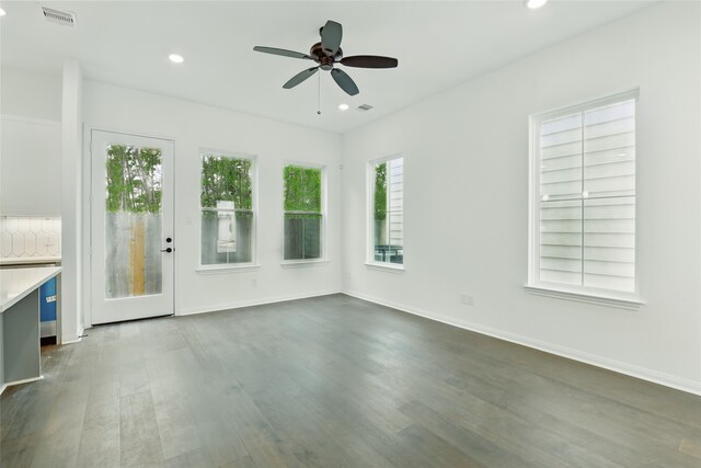 unfurnished living room featuring dark wood-style flooring, visible vents, baseboards, ceiling fan, and recessed lighting