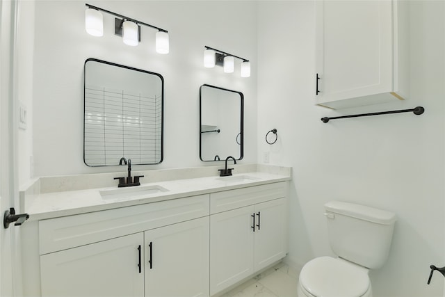 full bath featuring marble finish floor, double vanity, toilet, and a sink
