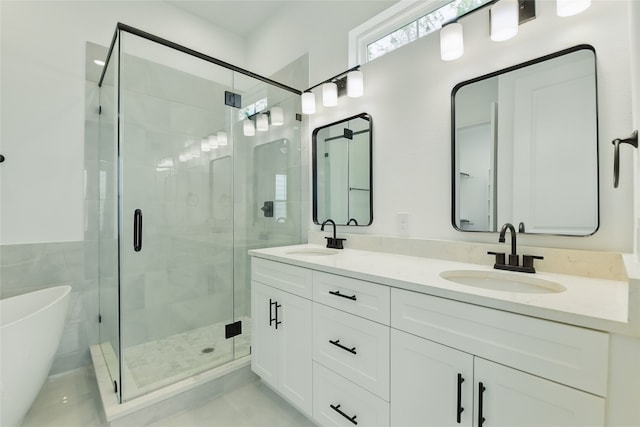 full bathroom with a shower stall, double vanity, a soaking tub, and a sink