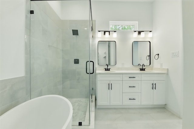 full bathroom with a freestanding tub, a sink, a stall shower, and double vanity