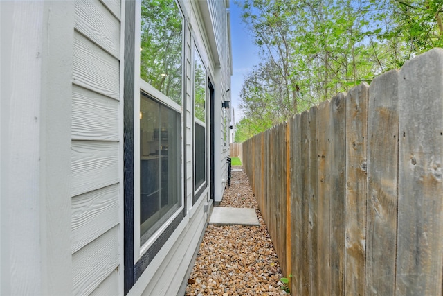 view of side of home featuring fence