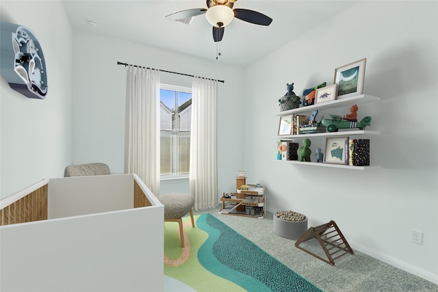 carpeted bedroom featuring baseboards and ceiling fan