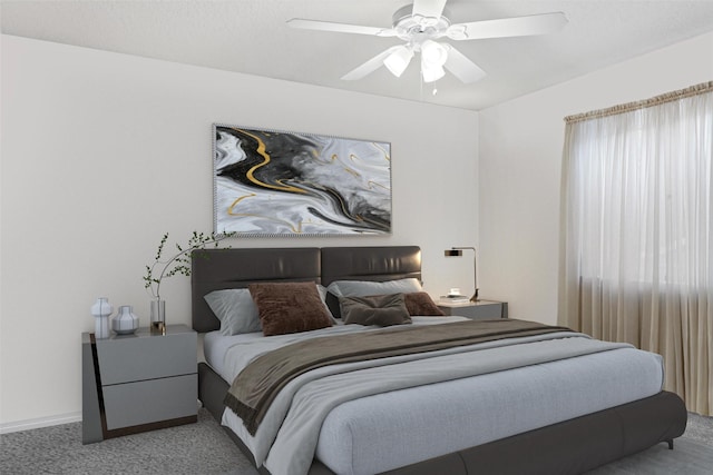 carpeted bedroom featuring baseboards and a ceiling fan