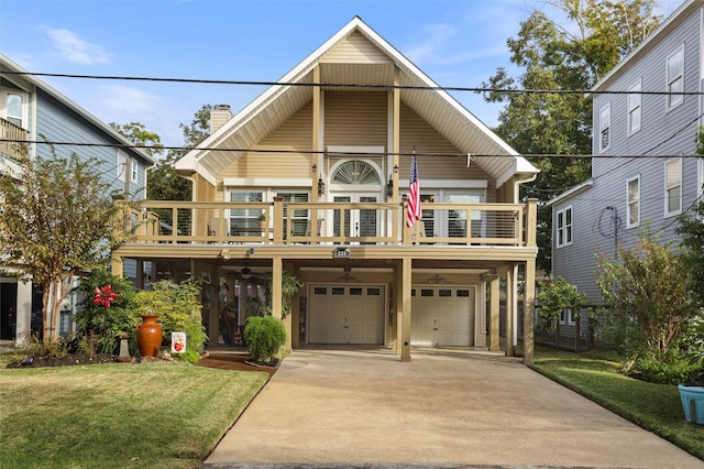 view of front of home featuring a front yard, driveway, an attached garage, and a chimney