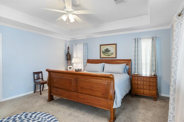 bedroom featuring visible vents, crown molding, carpet, baseboards, and a tray ceiling