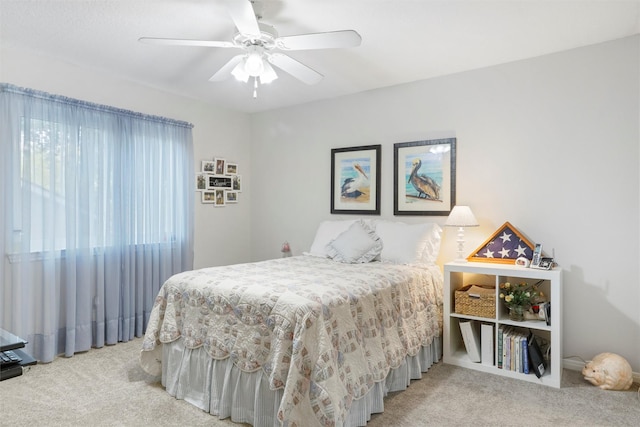 carpeted bedroom with a ceiling fan