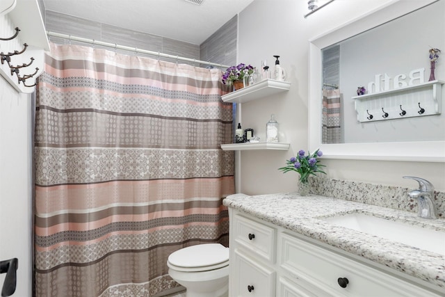 bathroom with a shower with curtain, toilet, and vanity