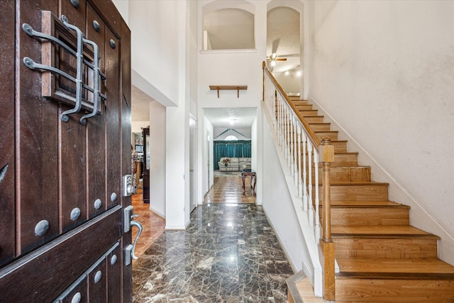 16023 Williwaw Dr, Houston, TX 77083 - foyer entrance featuring stairway, baseboards, a high ceiling, marble finish floor, and a ceiling fan
