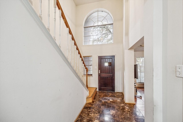 16023 Williwaw Dr, Houston, TX 77083 - foyer featuring marble finish floor, a towering ceiling, stairway, and a healthy amount of sunlight