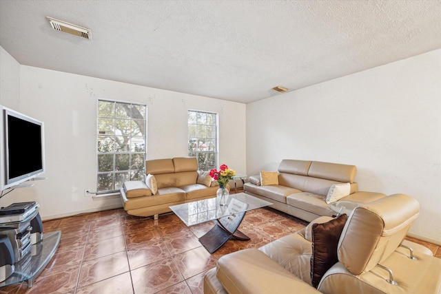 16023 Williwaw Dr, Houston, TX 77083 - tiled living room with a textured ceiling, baseboards, and visible vents