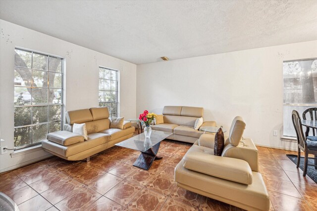 16023 Williwaw Dr, Houston, TX 77083 - living room featuring tile patterned floors, a textured ceiling, and visible vents