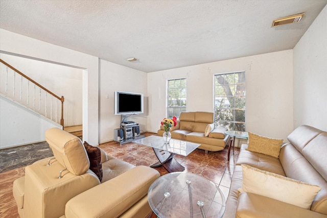 16023 Williwaw Dr, Houston, TX 77083 - living area featuring stairs, visible vents, and a textured ceiling