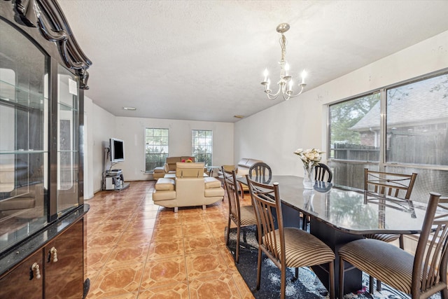 16023 Williwaw Dr, Houston, TX 77083 - dining space featuring light tile patterned flooring, a notable chandelier, and a textured ceiling
