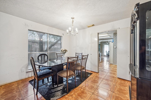 16023 Williwaw Dr, Houston, TX 77083 - dining room with a textured ceiling, visible vents, a notable chandelier, and light tile patterned floors