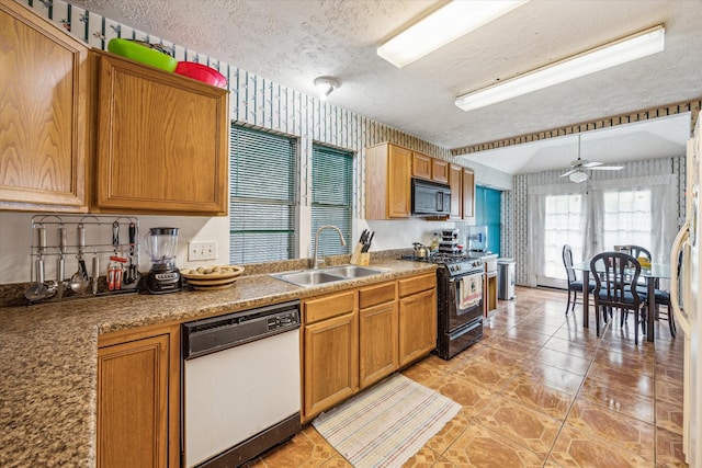 16023 Williwaw Dr, Houston, TX 77083 - kitchen with a sink, a ceiling fan, a textured ceiling, brown cabinetry, and black appliances
