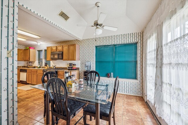 16023 Williwaw Dr, Houston, TX 77083 - dining room featuring light tile patterned flooring, wallpapered walls, a ceiling fan, lofted ceiling, and visible vents