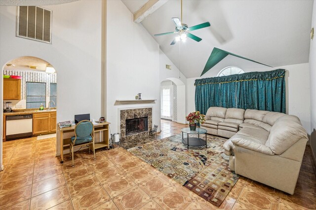 16023 Williwaw Dr, Houston, TX 77083 - living room with visible vents, a high end fireplace, beamed ceiling, arched walkways, and ceiling fan