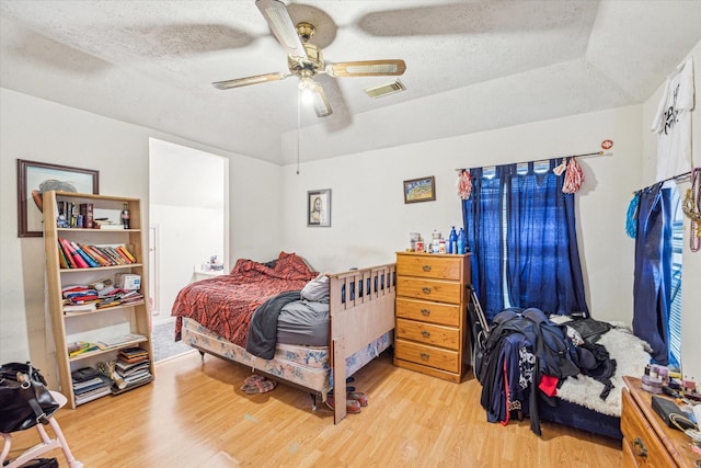 16023 Williwaw Dr, Houston, TX 77083 - bedroom featuring wood finished floors, a textured ceiling, ceiling fan, and visible vents