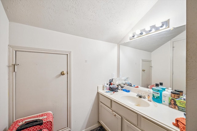 16023 Williwaw Dr, Houston, TX 77083 - bathroom with a textured ceiling, vaulted ceiling, and vanity