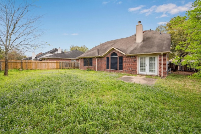 16023 Williwaw Dr, Houston, TX 77083 - rear view of house with french doors, brick siding, a fenced backyard, a patio, and a yard