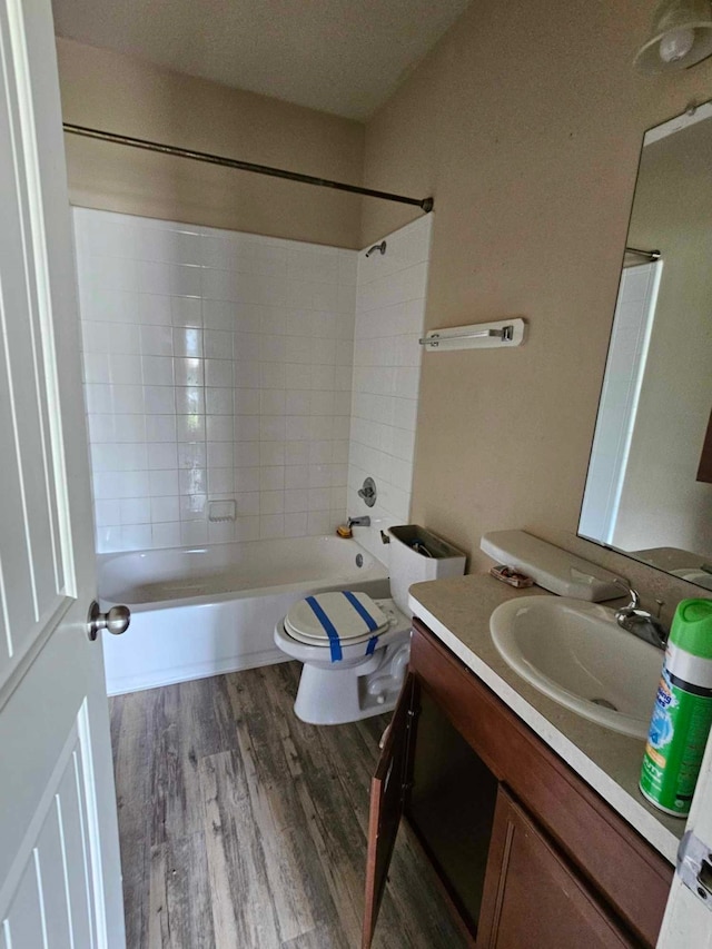 1710 Penina Dr, Crosby, TX 77532 - bathroom featuring wood finished floors, toilet, vanity, and bathing tub / shower combination