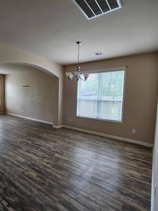 1710 Penina Dr, Crosby, TX 77532 - empty room with arched walkways, visible vents, baseboards, a notable chandelier, and dark wood-style floors