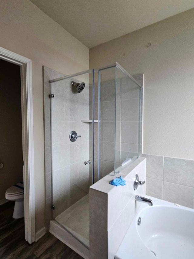 1710 Penina Dr, Crosby, TX 77532 - full bathroom featuring a bath, wood finished floors, and a stall shower