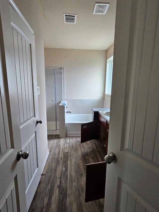1710 Penina Dr, Crosby, TX 77532 - bathroom with wood finished floors, vanity, visible vents, and a shower stall