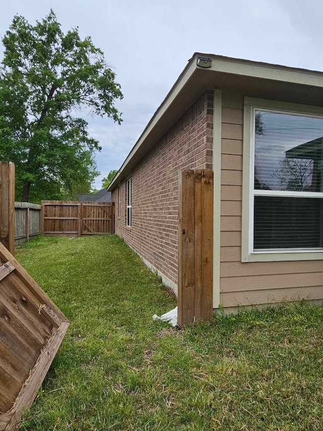 1710 Penina Dr, Crosby, TX 77532 - view of side of home featuring fence, brick siding, and a yard