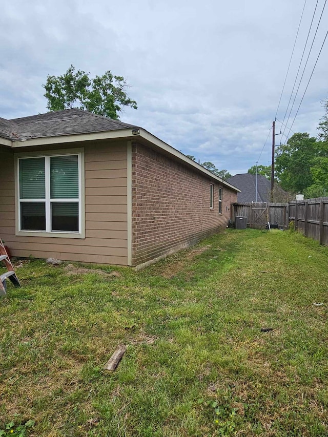 1710 Penina Dr, Crosby, TX 77532 - view of home's exterior with brick siding, fence, and a yard