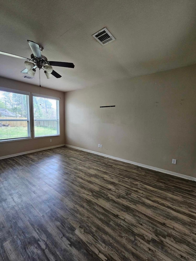 1710 Penina Dr, Crosby, TX 77532 - spare room with dark wood finished floors, visible vents, a ceiling fan, and baseboards
