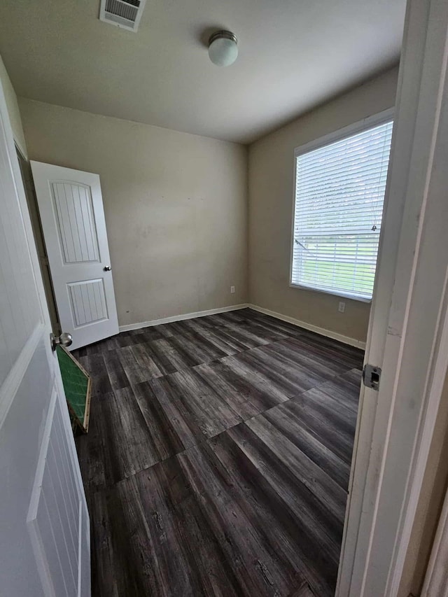 1710 Penina Dr, Crosby, TX 77532 - unfurnished room with dark wood finished floors, visible vents, and baseboards