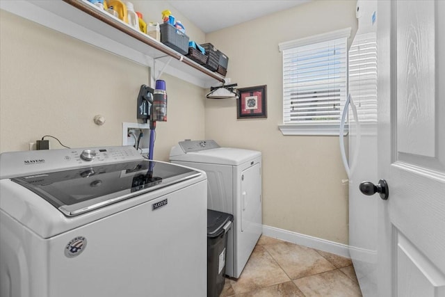 2052 Doolan Dr, Conroe, TX 77301 - laundry room with separate washer and dryer, baseboards, and light tile patterned floors