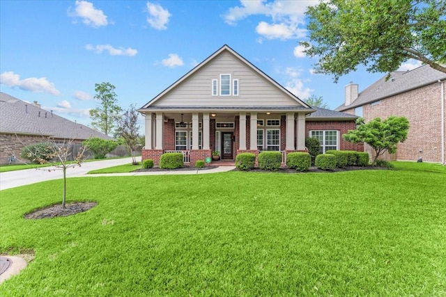 2052 Doolan Dr, Conroe, TX 77301 - greek revival house with brick siding, a front yard, and covered porch