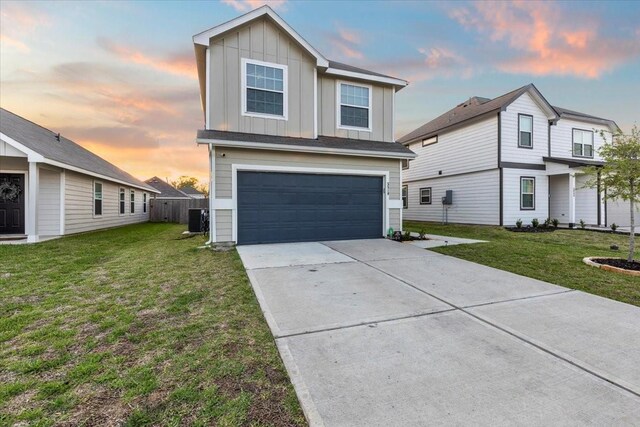 5510 Brooklyn Rose Dr, Rosharon, TX 77583 - view of front of home featuring an attached garage, board and batten siding, central AC, concrete driveway, and a lawn