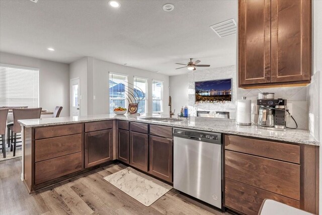 5510 Brooklyn Rose Dr, Rosharon, TX 77583 - kitchen featuring stainless steel dishwasher, a sink, light wood-style floors, light stone counters, and recessed lighting