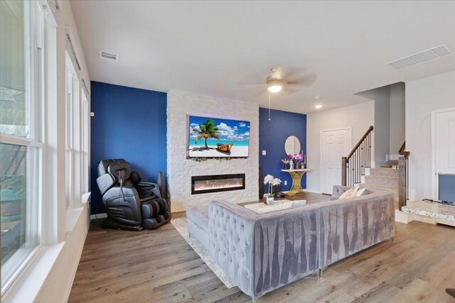 5510 Brooklyn Rose Dr, Rosharon, TX 77583 - living room featuring stairway, a fireplace, wood finished floors, a ceiling fan, and healthy amount of natural light