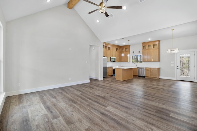 unfurnished living room with ceiling fan with notable chandelier, visible vents, beam ceiling, and dark wood-type flooring