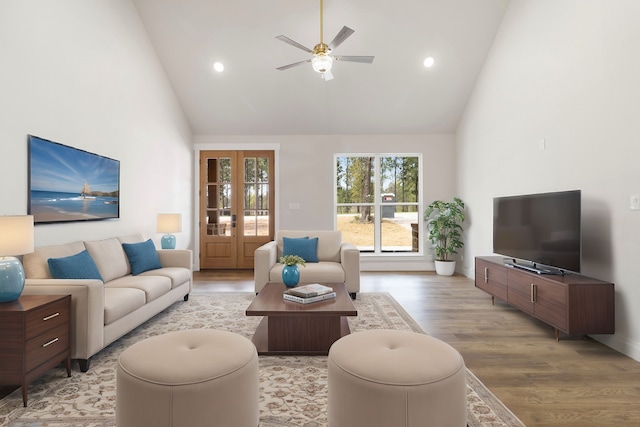 living area with high vaulted ceiling, recessed lighting, light wood-style floors, and a ceiling fan