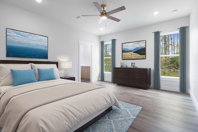 bedroom featuring multiple windows, light wood-style floors, and recessed lighting